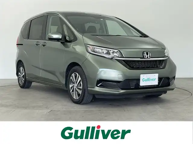 ホンダ フリード＋ ハイブリット G 大分県 2023(令5)年 2.2万km シルバーミストグリーンM 純正9インチナビ/　フルセグ/BT/CD/DVD/ビルトインETC/前方・後方ドライブレコーダー/両側パワースライドドア/レーダークルーズコントロール/コーナーセンサー/衝突被害軽減ブレーキ/レーンキープアシスト/先行車発進お知らせ機能/標識認知機能/シートヒーター/純正15インチアルミホイール/純正フロアマット/LEDヘッドライト/スペアキー