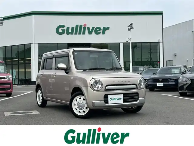 スズキ ラパン ショコラ G 愛媛県 2013(平25)年 3.3万km シャンパンピンクPM 登録時走行距離:32281km/スマートキー/純正フロアマット/純正アルミホイール/本革ステアリング/ツートンレザーシート/純正FM/CDプレーヤー/シガーソケット/ＡＣ/HIDヘッドライト/アイドリングストップ/盗難防止装置/ABS/パワステ/パワーウィンドウ/エアバッグ