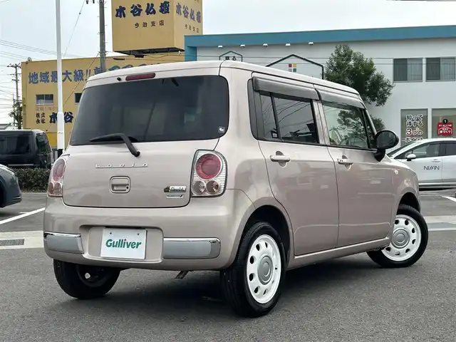 スズキ ラパン ショコラ G 愛媛県 2013(平25)年 3.3万km シャンパンピンクPM 登録時走行距離:32281km/スマートキー/純正フロアマット/純正アルミホイール/本革ステアリング/ツートンレザーシート/純正FM/CDプレーヤー/シガーソケット/ＡＣ/HIDヘッドライト/アイドリングストップ/盗難防止装置/ABS/パワステ/パワーウィンドウ/エアバッグ