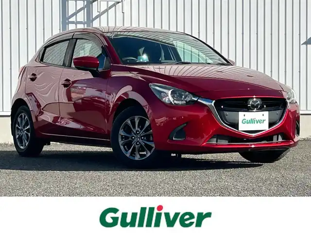 マツダ デミオ 13S ツーリング 熊本県 2018(平30)年 5.7万km ソウルレッドクリスタルM 純正7インチSDナビ/AM/FM/CD/DVD/TV/Bluetooth/フルセグTV/バックカメラ／全方位カメラ/ETC/ドライブレコーダー(前後）/ABS/横滑り防止装置/盗難防止装置/車間認知支援システム/ブラインドスポットモニター/交通標識認識システム/ドライバーアテンションアラート/ヘッドアップディスプレイ/コーナーセンサー（前後）/衝突被害軽減ブレーキ/レーダークルーズコントロール/レーンキープアシスト/布シート/シートヒーター（D/N)/LEDヘッドライト/オートライト/オートマチックハイビーム/プッシュスタート/アイドリングストップ/スマートキー/スペアキー/電動格納ミラー/ウィンカーミラー/ドアバイザー/純正フロアマット/15インチ純正AW/純正フロアマット