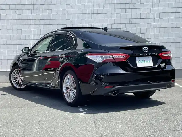 トヨタ カムリ G レザーパッケージ 愛知県 2019(令1)年 1.4万km アティチュードブラックマイカ ・純正メーカーナビ/・バックカメラ/・フルセグTV/・CD/DVD再生/・JBLサウンド/・ETC2.0/・Bluetooth/USB接続/・アダプティブクルーズコントロール/・MTモード付きAT/・パワーシート（D/N）/・シートヒーター（D/N）/・パノラマムーンルーフ/・純正フロアマット/・純正１８インチアルミホイール/・LEDヘッドライト/・オートマチックハイビーム/・コーナーセンサー/・横滑り防止装置/・プリクラッシュセーフティ/・レーンディパーチャーアラート（ステアリング制御機能付き）/・ブラインドスポットモニター/・電動パーキングブレーキ/・ブレーキホールド/・ドライブレコーダー（前）/・AC100V/・ステアリングアシステッドビークルスタビリティコントロール/・セカンダリーコリジョンブレーキ/・オートグライドコントロール