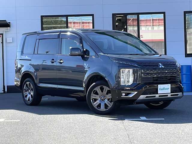 三菱 デリカＤ：５ ジャスパー 山口県 2023(令5)年 2.6万km グラファイトグレーメタリック/ブラックマイカ 純正メモリナビ/・DVD再生機能有/・Bluetooth接続/・アラウンドビューモニター/・フルセグTV/ビルトインETC/ドライブレコーダー/e-Assist/・車線逸脱警報システム/・レーダークルーズコントロール/・衝突被害軽減ブレーキシステム/・オートマチックハイビーム/・後側方車両検知警報システム/・誤発進抑制機能/両側パワースライドドア/ステアリングヒーター/ハーフレザーシート/シートカバー/パワーシートD席/シートヒーター/USB入力端子/パドルシフト/スマートキー/プッシュスタート/パワーバックドア/純正18インチアルミホイール/純正LEDライト/ドアバイザー/保証書