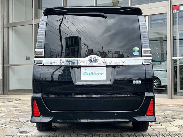 トヨタ ヴォクシー ハイブリッド ZS 煌Ⅱ 静岡県 2019(平31)年 8.2万km ブラック 【主要装備】/純正１０インチナビ　/フルセグテレビ　/純正１２インチフリップダウンモニター　/両側パワースライドドア　/純正１６インチアルミホイール　/前席シートヒーター　/ＥＴＣ　/ステアリングスイッチ　/スペアキー有り/プッシュスタート/スマートキー/クルーズコントロール/オートマチックハイビーム/プリクラッシュセーフティ