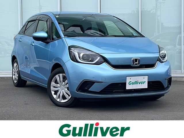ホンダ フィット e:HEVホーム 神奈川県 2021(令3)年 1.8万km ライトブルー 純正７インチＳＤナビ　CD/iPod/Bluetooth　/バックカメラ　/前後コーナーセンサー　/追従型クルーズコントロール　/ＬＥＤヘッドライト　/ＵＳＢポート　/ビルトインＥＴＣ　/スマートキー　/純正フロアマット　/ドアバイザー/衝突被害軽減システム/カーテンエアバッグ