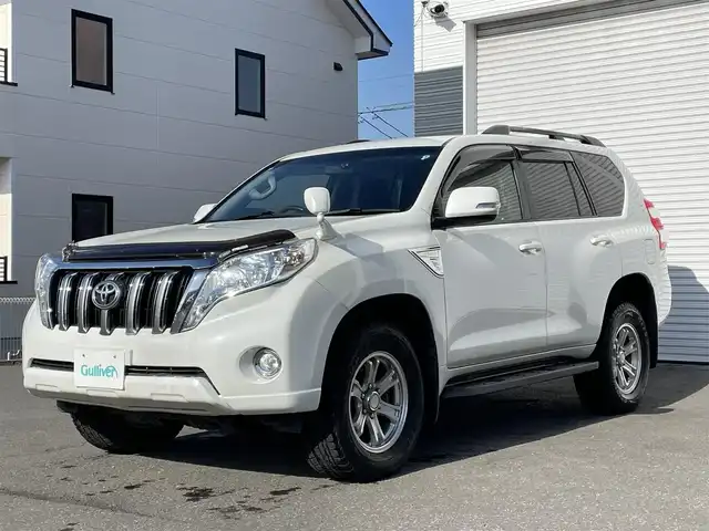 トヨタ ランドクルーザー プラド TX 道央・札幌 2015(平27)年 15.1万km ホワイトパールクリスタルシャイン 登録時走行距離150634km/　4　W　D　/寒冷地仕様/ディーゼルターボ/純正ディーラーOPナビ/バックカメラ/フロントワイパーデアイサー/ビルトインETC/電動格納ミラー/オールオートウィンドウ/ルーフレール/ダウンヒルアシストコントロール/プッシュスタート/純正フロアマット/純正ドアバイザー/スマートキー/スペアキー×１/純正AW付夏タイヤ積み込み