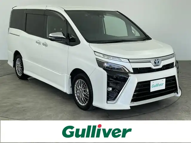 トヨタ ヴォクシー ハイブリッド ZS 煌Ⅱ 大分県 2020(令2)年 7.2万km ホワイトパールクリスタルシャイン ALPINE製11インチナビ(EX11NX)/バックカメラ/ALPINE製フリップダウンモニター/ALPINE製ドライブレコーダー/両側パワースライドドア/フルセグTV/テレビキャンセラー/HDMI端子/Bluetooth/ETC/前席シートヒーター/16インチアルミホイール/車線逸脱防止システム/衝突軽減ブレーキ/USB端子/オートライト/オートハイビーム/フォグランプ/LEDヘッドライト/本革巻きステアリング/ステアリングリモコン/ウォークスルー/前後コーナーセンサー/横滑り防止システム/スマートキー/プッシュスタート