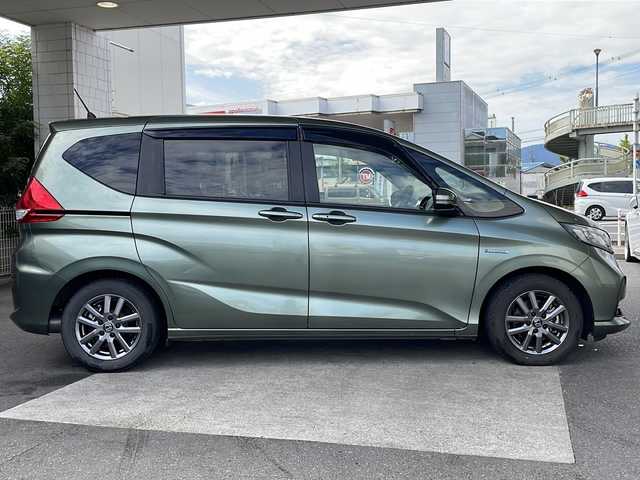 ホンダ フリード ハイブリット G ホンダセンシング 京都府 2021(令3)年 6万km シルバーミストグリーンM ワンオーナー /無限ドアパーツ /7インチ純正SDナビ（VXM-214VFi）/フルセグTV/Bluetooth/CD/DVD再生機能/iPod/AUX/USB/衝突軽減ブレーキ /禁煙 /両側パワースライドドア /後方コーナーセンサー /クルコン追従有 /レーンキープアシスト/シートヒーター/エアシート /シートカバー付/前方純正ドライブレコーダー /純正AW15インチ/ウィンカーミラー/オートライト