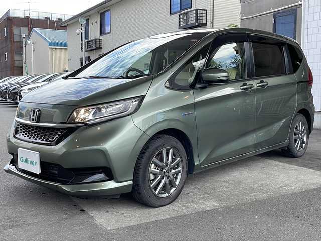 ホンダ フリード ハイブリット G ホンダセンシング 京都府 2021(令3)年 6万km シルバーミストグリーンM ワンオーナー /無限ドアパーツ /7インチ純正SDナビ（VXM-214VFi）/フルセグTV/Bluetooth/CD/DVD再生機能/iPod/AUX/USB/衝突軽減ブレーキ /禁煙 /両側パワースライドドア /後方コーナーセンサー /クルコン追従有 /レーンキープアシスト/シートヒーター/エアシート /シートカバー付/前方純正ドライブレコーダー /純正AW15インチ/ウィンカーミラー/オートライト
