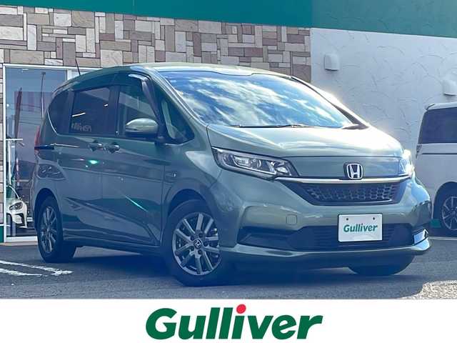 ホンダ フリード ハイブリット G ホンダセンシング 徳島県 2021(令3)年 6万km シルバーミストグリーンM ワンオーナー /無限ドアパーツ /7インチ純正SDナビ（VXM-214VFi）/フルセグTV/Bluetooth/CD/DVD再生機能/iPod/AUX/USB/衝突軽減ブレーキ /禁煙 /両側パワースライドドア /後方コーナーセンサー /クルコン追従有 /レーンキープアシスト/シートヒーター/エアシート /シートカバー付/前方純正ドライブレコーダー /純正AW15インチ/ウィンカーミラー/オートライト