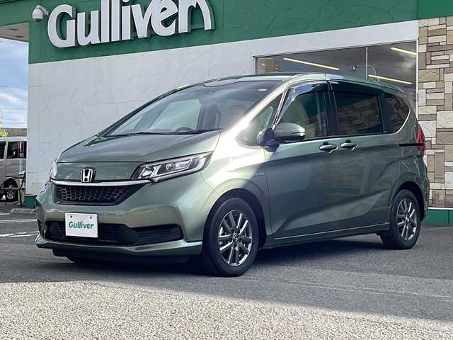 ホンダ フリード ハイブリット G ホンダセンシング 徳島県 2021(令3)年 6万km シルバーミストグリーンM ワンオーナー /無限ドアパーツ /7インチ純正SDナビ（VXM-214VFi）/フルセグTV/Bluetooth/CD/DVD再生機能/iPod/AUX/USB/衝突軽減ブレーキ /禁煙 /両側パワースライドドア /後方コーナーセンサー /クルコン追従有 /レーンキープアシスト/シートヒーター/エアシート /シートカバー付/前方純正ドライブレコーダー /純正AW15インチ/ウィンカーミラー/オートライト