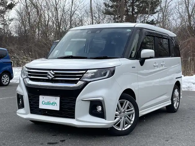 スズキ ソリオ HV MZ 青森県 2021(令3)年 7.3万km ピュアホワイトP ワンオーナー/4WD/セーフティサポート/・デュアルカメラブレーキサポート/・後退時ブレーキサポート/・誤発進抑制機能/・アダプティブクルーズコントロール/・ブラインドスポットモニター/・車線逸脱抑制機能/・ハイビームアシスト/・ヘッドアップディスプレイ/社外メモリナビ/　 CD/DVD/SD/BT/フルセグTV/両側パワースライドドア/LEDオートライト/フォグランプ/純正15インチアルミホイール/シートヒーター/純正エンジンスターター/アイドリングストップ/スマートキー