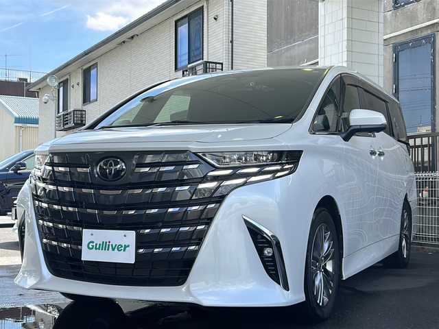 トヨタ アルファードハイブリット Z 京都府 2023(令5)年 1.5万km プラチナホワイトパールマイカ 純正ディスプレイオーディオナビ/フルセグTV/Bluetooth/Miracast/HDMI/FM/AM/全方位カメラ/ツインムーンルーフ/3眼LEDヘッドライト/後席用パワーサンシェード/両側パワースライドドア/パワーバックドア/運転席ポジションメモリー/全席パワーシート/全席シートヒーター/全席エアーシート/ステアリングヒーター/ステアリングスイッチ/前後ドラレコ/ビルトインETC2.0/純正フロアマット/純正ドアバイザー/電格ウィンカーミラー/トヨタセーフティセンス/BSM/置くだけ充電/禁煙車