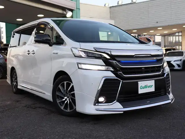 トヨタ ヴェルファイア ハイブリット ZR Gエディション 神奈川県 2016(平28)年 3.8万km ホワイトパールクリスタルシャイン モデリスタエアロ/モデリスタマフラー/寒冷地仕様/純正１０型ナビ/フルセグＴＶ/置くだけ充電/インテリアイルミネーション/ＴＶキャンセラー/ステアリングヒーター/前席シートヒーター/パワーバックドア/オートマチックハイビーム/ETC/両側パワースライドドア/黒革シート/クルーズコントロール