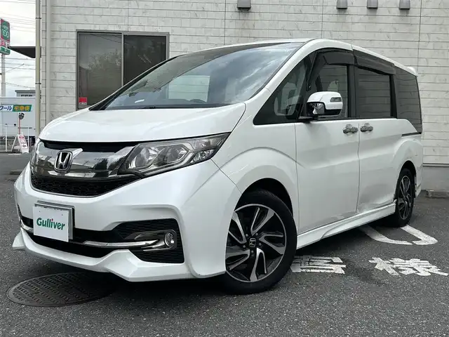 ホンダ ステップワゴン スパーダ クールスピリット 埼玉県 2017(平29)年 10.2万km ホワイトオーキッドパール ワンオーナー/Honda SENSING/・衝突軽減ブレーキ (CMBS)/・路外逸脱抑制機能/・渋滞追従機能付アダプティブクルーズコントロール/　 (ACC)/・車線維持支援システム (LKAS)/純正9インチメモリナビ　（VXM-175VFNi）/DTV/CD/DVD/BT/USB/iPod/AUX/AppleCarPlay/SD/SDREC/両側パワースライドドア/パドルシフト/前席ヒートシーター/純正ビルトインETC　/社外前後ドライブレコーダー（CSD-790FHG）/スマートキー/スペアキー/VSA（ビークルスタビリティアシスト）/　・ABS機能　/　・TCS（トラクションコントロールシステム）機能/　・横滑り抑制機能/盗難防止装置　/アイドリングストップ