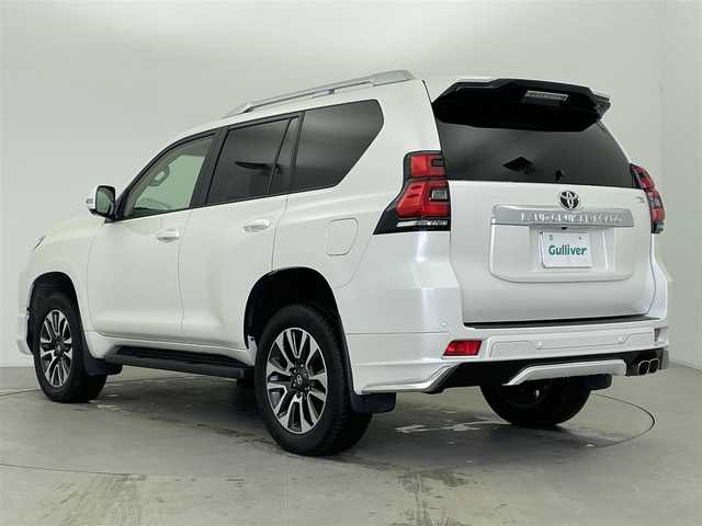 トヨタ ランドクルーザー プラド TX Lパッケージ 富山県 2022(令4)年 0.9万km ホワイトパールクリスタルシャイン サンルーフ/モデリスタエアロ/モデリスタスポーツマフラー/純正9型ナビ（AM/FM/BT/USB）/全方位カメラ/レザーシート/D/N席パワーシート/シートヒーター/エアシート/ブラインドスポットモニター/衝突被害軽減システム/レーダークルーズコントロール/レーンキープアシスト/コーナーセンサー/横滑り防止装置/オートLEDライト/ETC/純正アルミホイール/純正フロアマット/スマートキー/スペアキー