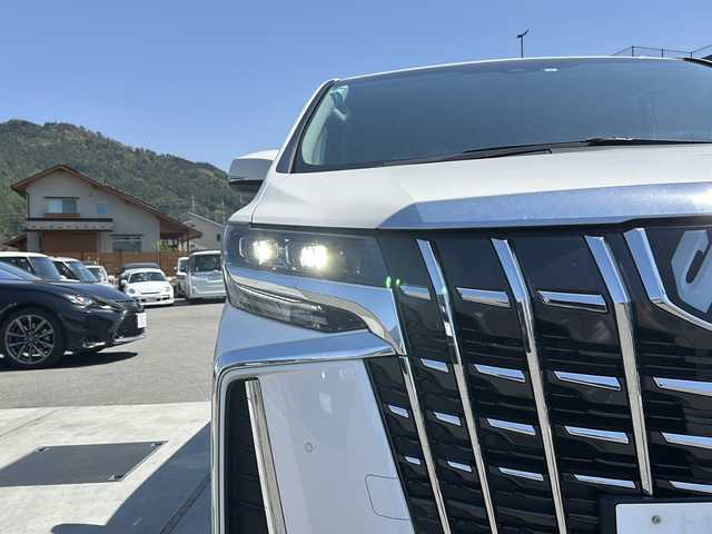 トヨタ アルファード S 山梨県 2023(令5)年 1.8万km ホワイトパールクリスタルシャイン ディスプレイオーディオ/バックカメラ/両側パワースライドドア/ETC/クルーズコントロール/禁煙車/LEDヘッドライト/Bluetooth再生/純正１８インチアルミ/衝突軽減システム/オートマチックハイビーム/コーナーセンサー/スペアキー/フリップダウンモニター