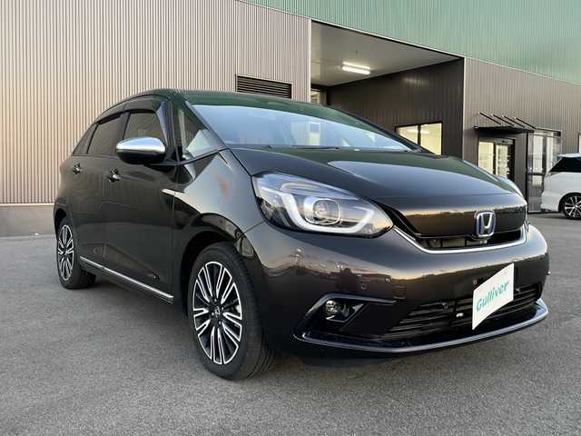 ホンダ フィット e:HEVリュクス 新潟県 2020(令2)年 2.4万km プレミアムグラマラスブロンズP 純正9インチナビ/バックカメラ/置くだけ充電/Blueooth/USB/プッシュスタート/スマートキー/ETC/ホンダエセンシング/シートヒーター/LEDヘッドライト/ハーフレザー/前後ドラレコ/純正フロアマット/純正アルミホイール