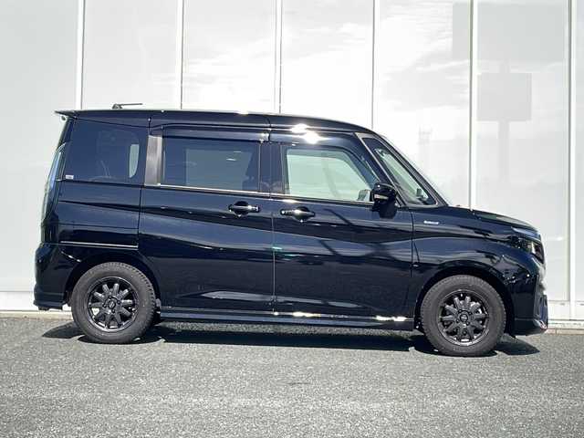 スズキ ソリオ バンディット HV MV 福岡県 2021(令3)年 1.5万km スーパーブラックパール 純正9インチナビ/【AM/FM/DISC/フルセグTV/BT/USB】/全方位モニター/ルームミラー型前後ドラレコ/ワンオーナー/ヘッドアップディスプレイ/デュアルカメラブレーキサポート/レーダークルーズコントロール/リヤコーナーセンサー/両側パワースライドドア/電動格納ミラー/LEDヘッドライト＆フォグランプ/ステアリングスイッチ/プッシュスタート/ETC/後席サンシェード/後席用テーブル/リアサーキュレーター/純正ドアバイザー/スペアタイヤ/オールシーズンタイヤ装着