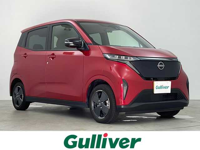日産 サクラ G 鹿児島県 2023(令5)年 2.4万km スパークリングレッドM スマートキー×2/純正EV専用NissanConnectナビゲーションシステム/アラウンドビューモニター（移動物検知機能付）/前後ドライブレコーダー/プロパイロット/・インテリジェント クルーズコントロール/・ハンドル支援/・VDC（ビークルダイナミクスコントロール/・ABS（アンチロックブレーキシステム）/LEDヘッドライト/LEDポジションランプ（アクセント機能付）/LEDリヤコンビネーションランプ/D席シートヒーター/ステアリングヒーター/充電ケーブル/LEDヘッドライト/コーナーセンサー/純正フロアマット/純正14インチアルミホイール/ビルトインETC2.0