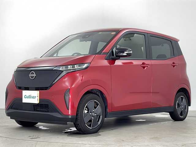 日産 サクラ G 鹿児島県 2023(令5)年 2.4万km スパークリングレッドM スマートキー×2/純正EV専用NissanConnectナビゲーションシステム/アラウンドビューモニター（移動物検知機能付）/前後ドライブレコーダー/プロパイロット/・インテリジェント クルーズコントロール/・ハンドル支援/・VDC（ビークルダイナミクスコントロール/・ABS（アンチロックブレーキシステム）/LEDヘッドライト/LEDポジションランプ（アクセント機能付）/LEDリヤコンビネーションランプ/D席シートヒーター/ステアリングヒーター/充電ケーブル/LEDヘッドライト/コーナーセンサー/純正フロアマット/純正14インチアルミホイール/ビルトインETC2.0