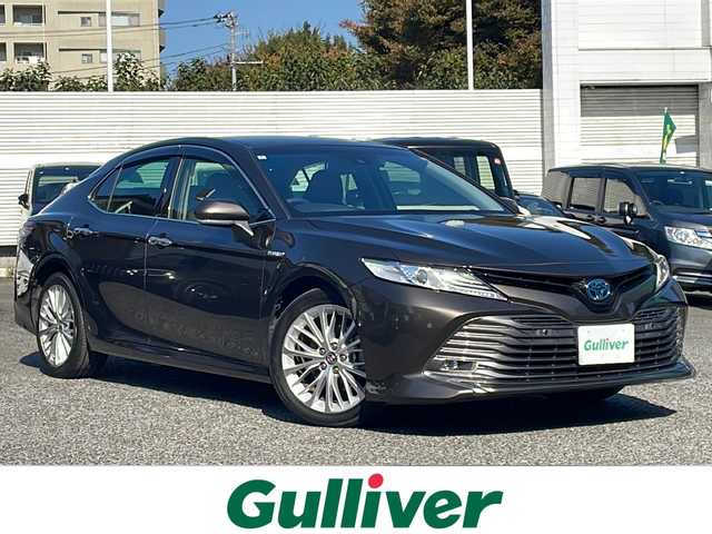 トヨタ カムリ G レザーパッケージ 東京都 2018(平30)年 7万km グラファイトM 純正SDナビ/（フルセグ/BT/CD/DVD/FM/AM）/ドライブレコーダー（前後）/バックカメラ　ETC2.0/ヘッドアップディスプレイ/Toyota Safety Sense P/・LDA・PCS・BSM/・オートマチックハイビーム/・レーダークルーズコントロール/レザーシート/シートヒーター（D/N）/パワーシート（D/N）/オートホールド/コーナーセンサー/スマートキー×２/純正１８インチアルミ/社外AW付スタッドレスタイヤ積載