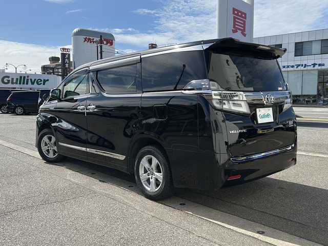 トヨタ ヴェルファイア ハイブリット X 富山県 2019(令1)年 6.7万km ブラック ワンオーナー/両側パワスラ/スマートキー×２/社外メモリーナビ(AVIC-CL902)/DVD/BT/USB/フルセグTV/ビルトインETC/ミラー型前後ドラレコ/社外フリップダウンモニター(TVM-FW1020)/LEDヘッドライト/フォグ/プッシュスタート/衝突安全ブレーキ/レーンキープアシスト/オートハイビーム/レーダークルコン/電動Pブレーキ/電格ウィンカーミラー/シートカバー/Clazzioフロアマット/電動Pブレーキ/皮巻きステアリング/ステアリングスイッチ/AC100V電源/保証書・取説・ナビ取説