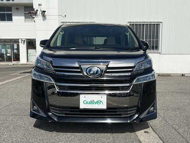 トヨタ ヴェルファイア ハイブリット X 富山県 2019(令1)年 6.7万km ブラック ワンオーナー/両側パワスラ/スマートキー×２/社外メモリーナビ(AVIC-CL902)/DVD/BT/USB/フルセグTV/ビルトインETC/ミラー型前後ドラレコ/社外フリップダウンモニター(TVM-FW1020)/LEDヘッドライト/フォグ/プッシュスタート/衝突安全ブレーキ/レーンキープアシスト/オートハイビーム/レーダークルコン/電動Pブレーキ/電格ウィンカーミラー/シートカバー/Clazzioフロアマット/電動Pブレーキ/皮巻きステアリング/ステアリングスイッチ/AC100V電源/保証書・取説・ナビ取説