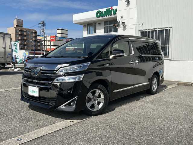 トヨタ ヴェルファイア ハイブリット X 富山県 2019(令1)年 6.7万km ブラック ワンオーナー/両側パワスラ/スマートキー×２/社外メモリーナビ(AVIC-CL902)/DVD/BT/USB/フルセグTV/ビルトインETC/ミラー型前後ドラレコ/社外フリップダウンモニター(TVM-FW1020)/LEDヘッドライト/フォグ/プッシュスタート/衝突安全ブレーキ/レーンキープアシスト/オートハイビーム/レーダークルコン/電動Pブレーキ/電格ウィンカーミラー/シートカバー/Clazzioフロアマット/電動Pブレーキ/皮巻きステアリング/ステアリングスイッチ/AC100V電源/保証書・取説・ナビ取説