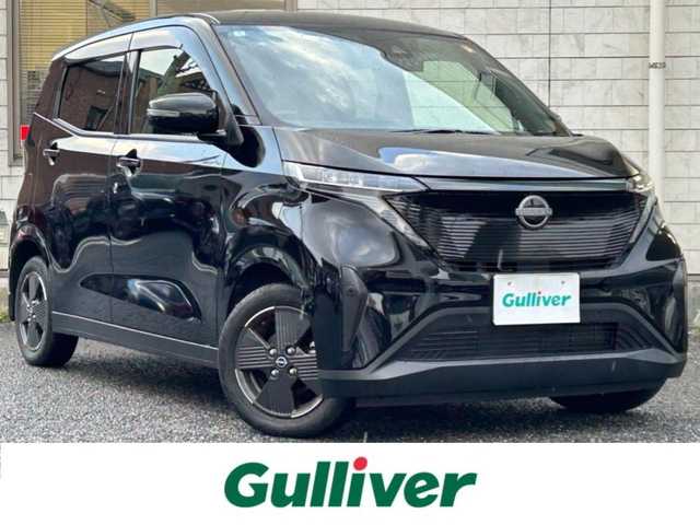 日産 サクラ X 福岡県 2022(令4)年 1.3万km ブラック ワンオーナー車/KENWOOD 9インチナビ【MDF-M910HDF】/（FM/AM/CD/DVD/Bluetooth/フルセグＴＶ）/運転支援/・車線逸脱警報/・踏み間違い衝突防止/・先行車発進お知らせ/・速度/道路標識表示/・フロント/リヤソナー/・ふらつき警報/横滑り防止/オートライト/ハイビームアシスト/純正14インチアルミホイール/コムテック前後ドライブレコーダー【ZDR035】/ビルトインＥＴＣ/e-Pedal Step/ドライブモードセレクター/純正フロアマット/純正ドアバイザー/電動パーキングブレーキ/プッシュスタート/充電ケーブル/スペアキー×1/アクセサリーソケット/ISOFIX/保証書/取扱説明書