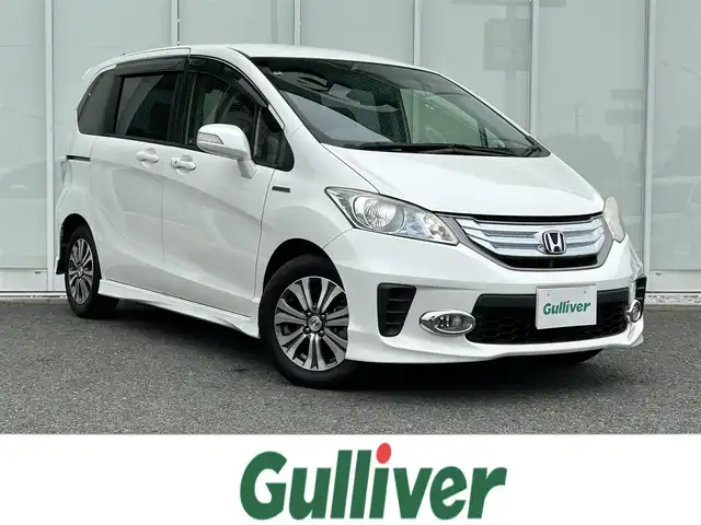 ホンダ フリード ハイブリット ジャストセレクション+ 福岡県 2014(平26)年 7万km ホワイトオーキッドパール ・純正ナビ/（バックカメラ/DVD再生/・ETC/・クルーズコントロール/・両側パワースライドドア/・ウォークスルー/・キセノンヘッドライト/・純正フロアマット/・アルミホイール/・CDチェンジャー/・スマートキー