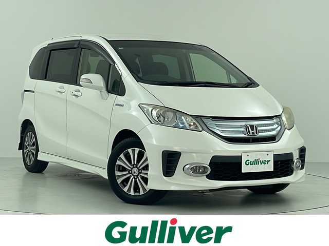 ホンダ フリード ハイブリット ジャストセレクション+ 大阪府 2014(平26)年 7万km ホワイトオーキッドパール クルーズコントロール/社外HDDナビ/(地デジ CD DVD)/HIDヘッドライト/オートライト/フォグライト/両側パワースライドドア/革巻きステアリング/ステアリングリモコン/電動格納ミラー/ウインカーミラー/ドアバイザー/純正フロアマット/スマートキー/ETC