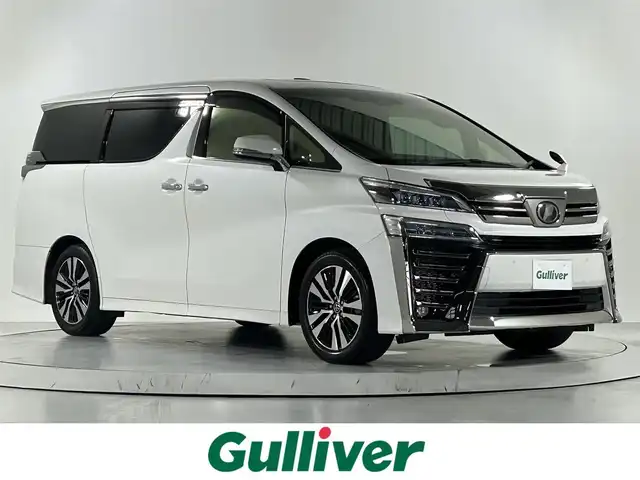トヨタ ヴェルファイア Z Gエディション 佐賀県 2018(平30)年 8.5万km ホワイトパールクリスタルシャイン 社外アルパイン製11インチナビ【EX１１Z】/【フルセグTV.CD.DVD.Bluetooth】/社外12.8インチフリップダウンモニター/ツインムーンルーフ/デジタルインナールームミラー/衝突被害軽減システム/レーダークルーズコントロール/レーンアシスト/パーキングサポートブレーキ/クリアランスソナー/カーテンエアバッグ/ロードサインアシスト/オートブレーキホールド/オートマチックハイビーム/オートライト/バックカメラ/3眼LEDヘッドライト/前方ドライブレコーダー/両側パワースライドドア/パワーバッグドア/運転席・助手席パワーシート/メモリーシート/運転席・助手席シートヒーター/運転席・助手席エアシート/ビルトインETC/ステアリングヒーター/純正18インチアルミホイール/合皮シート/フォグライト