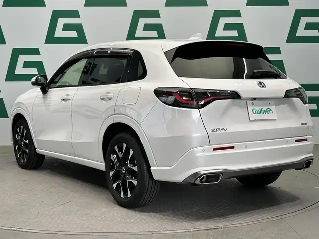 ホンダ ＺＲ－Ｖ ハイブリッド e:HEV Z 鹿児島県 2024(令6)年 1.2万km プラチナホワイトパール ホンダセンシング/・衝突軽減ブレーキ/・誤発進抑制機能（前後）/・近距離衝突軽減ブレーキ/・歩行者事故低減ステアリング/・路外逸脱抑制機能/・渋滞追従機能付アダプティブクルーズコントロール/・車線維持支援システム/・トラフィックジャムアシスト/・先行車発進お知らせ機能/・標識認識機能/・アダプティブドライビングビーム/・ブラインドスポットインフォメーション/・パーキングセンサーシステム/・後退出庫サポート/マルチビューカメラシステム/BOSEプレミアムサウンドシステム/ワイヤレス充電/純正9インチメモリナビ【LXM-247VFNi】/（フルセグ/BT/AppleCarPlay/AndroidAuto/USB）/ビルトインETC2.0/社外前後ドライブレコーダー/革巻きステアリング/ステアリングリモコン/パドルシフト/ステアリングヒーター/レザーシート/前席パワーシート/運転席シートメモリ/前席シートヒーター/ハンズフリーパワーテールゲート/純正LEDヘッドライト/オートライト/フロント&バックソナー/純正ラバーマット/純正18インチアルミ