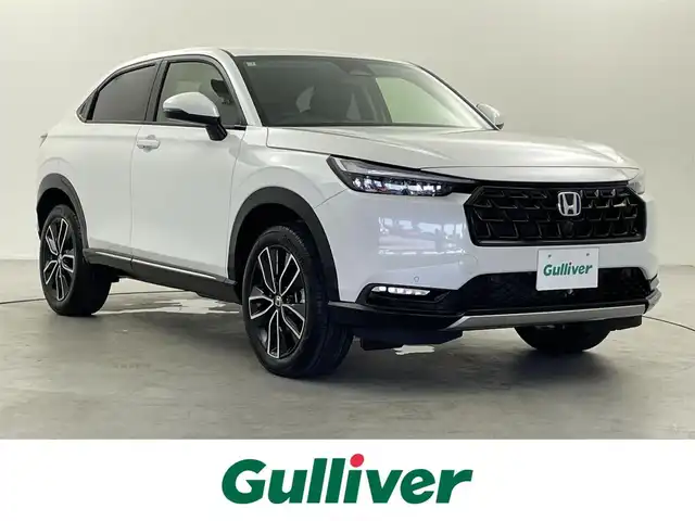 ホンダ ヴェゼル ハイブリッド e:HEV Z 福井県 2025(令7)年 0.1千km プラチナホワイトパール 登録済未使用車　/Ｈｏｎｄａ　ＣＯＮＮＥＣＴディスプレイオーディオ/（ナビ機能付き）/オプションフロントグリル　（ベルリナブラック）/置くだけ充電　/ハーフレザーシート　/シートヒーター　/ハンドルヒーター　/スペアキー　/純正ビルトインＥＴＣ２．０/純正アルミホイール/ABS/レーンキープアシスト/横滑り防止装置/オートライト/前後コーナーセンサー/ヒルディセントコントロール/LEDヘッドライト
