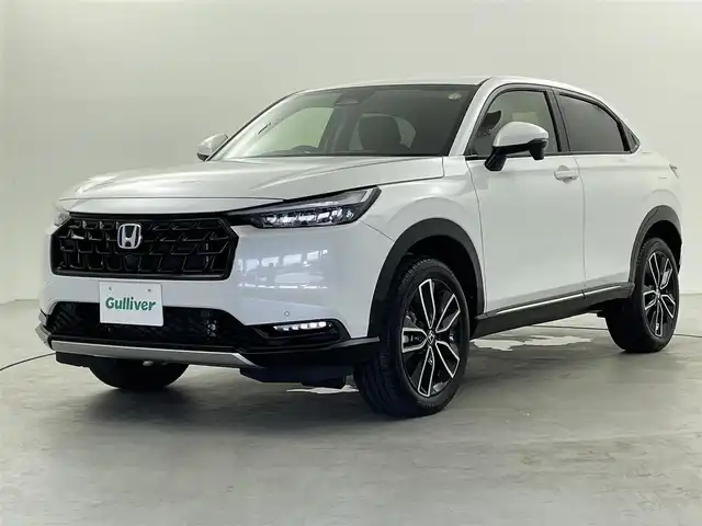 ホンダ ヴェゼル ハイブリッド e:HEV Z 福井県 2025(令7)年 0.1千km プラチナホワイトパール 登録済未使用車　/Ｈｏｎｄａ　ＣＯＮＮＥＣＴディスプレイオーディオ/（ナビ機能付き）/オプションフロントグリル　（ベルリナブラック）/置くだけ充電　/ハーフレザーシート　/シートヒーター　/ハンドルヒーター　/スペアキー　/純正ビルトインＥＴＣ２．０/純正アルミホイール/ABS/レーンキープアシスト/横滑り防止装置/オートライト/前後コーナーセンサー/ヒルディセントコントロール/LEDヘッドライト
