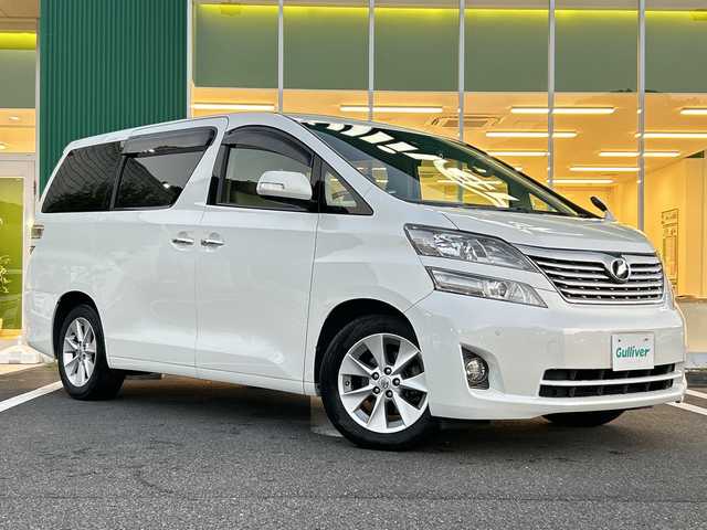 トヨタ ヴェルファイア 2．4V 愛媛県 2010(平22)年 9.6万km ホワイトパールクリスタルシャイン フリップダウンモニター/純正ナビ（NHZN-W60G）/・Bluetooth/・CD/DVD/フルセグTV/バックカメラ/ETC/両側パワースライドドア/ステアリングスイッチ/オートライト/オートマチックハイビーム/コーナセンサー/リモコンキー/スペアキー/保証書/取扱説明書