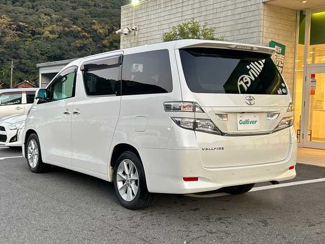 トヨタ ヴェルファイア 2．4V 愛媛県 2010(平22)年 9.6万km ホワイトパールクリスタルシャイン フリップダウンモニター/純正ナビ（NHZN-W60G）/・Bluetooth/・CD/DVD/フルセグTV/バックカメラ/ETC/両側パワースライドドア/ステアリングスイッチ/オートライト/オートマチックハイビーム/コーナセンサー/リモコンキー/スペアキー/保証書/取扱説明書