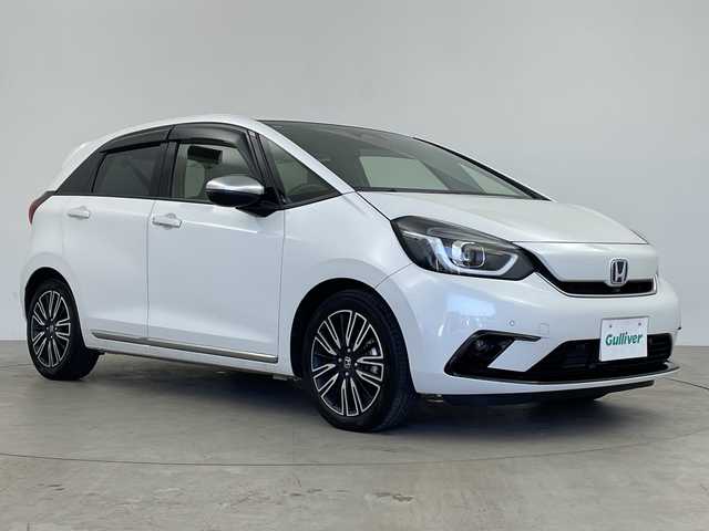 ホンダ フィット e:HEVリュクス 鹿児島県 2021(令3)年 1.7万km プラチナホワイトパール 純正SDナビ/(BT/CD/DVD/AM/FM/フルセグTV)/ホンダセンシング/レーダークルーズコントロール/衝突軽減ブレーキ/レーンキープアシスト/標識認識機能/踏み間違い防止機能/前席シートヒーター/レザーシート/革巻きステアリング/ステアリングスイッチ/アイドリングストップ/バックカメラ/前後ドライブレコーダー/チップアップシート/純正フロアマット/純正16インチアルミホイール/オートマチックハイビーム/純正LEDヘッドライト/保証書/取扱説明書/スペアキー