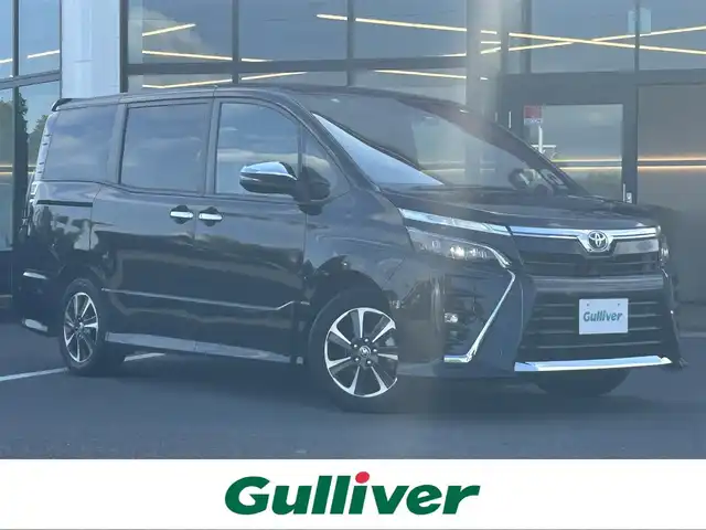 トヨタ ヴォクシー ZS 煌 栃木県 2018(平30)年 6.9万km ブラック トヨタセーフティセンス/純正10インチメモリナビ/フルセグTV/DVD/Bluetooth/MSV/純正フリップダウンモニター/バックカメラ/ETC/前後ドライブレコーダー/両側パワースライドドア/スマートキー/クルーズコントロール/ステアリングリモコン/シートバックテーブル/ロールサンシェード/LEDヘッドライト/フォグランプ/オートハイビーム/アイドリングストップ/横滑り防止装置