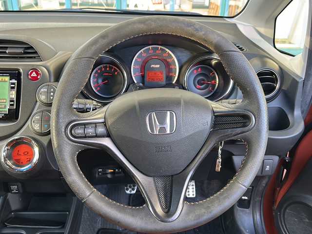 ホンダ フィット RS 愛知県 2012(平24)年 3.7万km サンセットオレンジⅡ 登録時走行距離36172キロ/純正ナビゲーション/６速マニュアルシフト/純正フロアマット/ワンセグＴＶ/横滑り装置/純正アルミホイール/助手席エアバック/オートライト