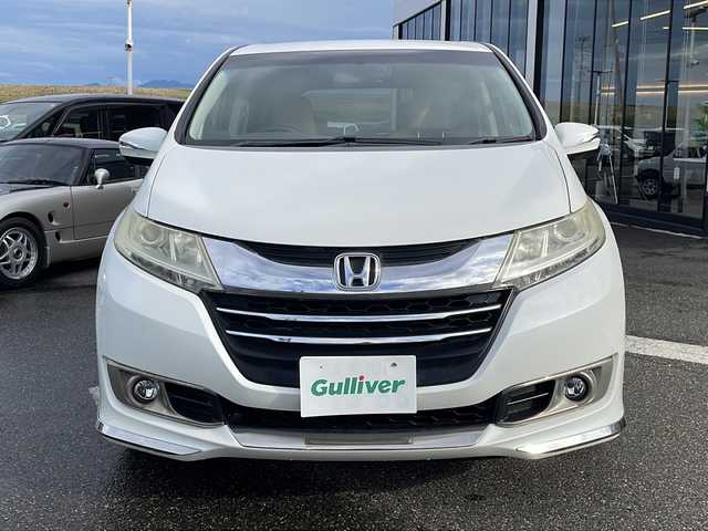 ホンダ オデッセイ G 新潟県 2014(平26)年 17.2万km ホワイトオーキッドパール 社外SDナビ/(BT/AM/FM/CD/フルセグTV)/レザーシート/スタッドレスタイヤ/片側パワースライドドア/フリップダウンモニター/オットマン/クルーズコントロール/ABS/横滑り防止装置/盗難防止装置/純正フロアマット
