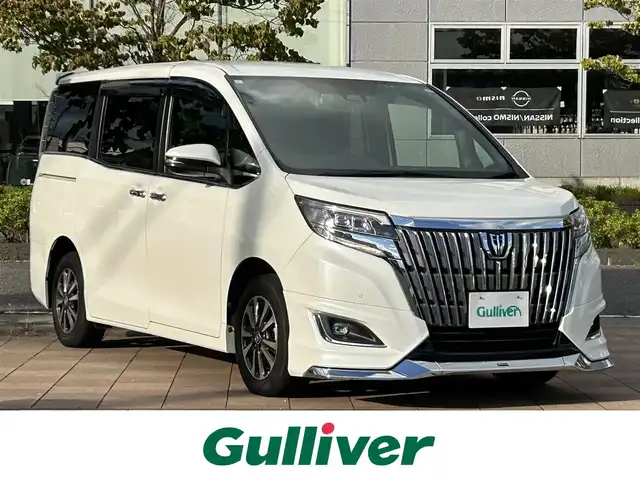 トヨタ エスクァイア Gi 福島県 2019(令1)年 3.7万km ホワイトパールクリスタルシャイン 純正9インチナビ/(FM/AM/CD/DVD/USB/TV/BT)/バックカメラ/フリップダウンモニター/ETC/前後ドライブレコーダー/モデリスタフロントスポイラー/両側パワースライドドア/前席シートヒーター/プリクラッシュセーフティ/レーンディパーチャーアラート/クルーズコントロール/クリアランスソナー/LEDヘッドライト/フォグライト/オートライト/オートマチックハイビーム/純正アルミ/純正フロアマット/ドアバイザー/アイドリングストップ/ステアリングスイッチ/横滑り防止装置