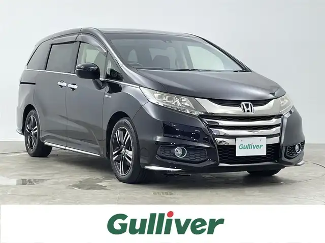 ホンダ オデッセイ ハイブリッド アブソルート EX パッケージ 千葉県 2016(平28)年 6.5万km クリスタルブラックパール 禁煙/フリップダウンモニター/ホンダセンシング/●衝突軽減ブレーキ 〈CMBS〉/●歩行者事故低減ステアリング/●ACC 〈アダプティブ・クルーズ・コントロール〉/●LKAS 〈車線維持支援システム〉/●路外逸脱抑制機能/●誤発進抑制機能/●先行車発進お知らせ機能/●標識認識機能/純正8インチナビ（VXM-175VFEi）/CD/DVD/Bluetooth/フルセグTV/バックカメラ/両側電動スライドドア/ブラインドスポットインフォメーション/ビルトインETC/横滑り防止機能/パワーシート/ハーフレザーシート/ステアリングリモコン/純正17インチアルミホイール/LEDヘッドライト/フォグライト/アクティブコーナリングライト/コンフォートビューパッケージ/AC電源1500W/2列目大型ロールサンシェード/純正フロアマット/スマートキー/スペアキー