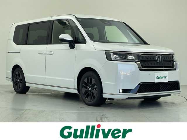 ホンダ ステップワゴン スパーダ eHEV 愛知県 2025(令7)年 0.1千km プラチナホワイトパール 登録済未使用車/純正１１インチナビ/・フルセグ/・Ｂｌｕｅｔｏｏｔｈ/・ＤＶＤ/・ＣＤ/・FM/AM/・AppleCarPlay/・AndroidAuto/両側パワースライドドア/バックカメラ/アダプティブクルーズコントロール/ホンダセンシング/衝突軽減ブレーキ/前後誤発進抑制機能/車線逸脱抑制機能/トラフィックジャムアシスト/車線維持支援システム/先行車発進お知らせ機能/オートマチックハイビーム/標識認識機能/コーナーセンサー/電動リアゲート/オットマン/パドルシフト/LEDヘッドライト/カーテンエアバック