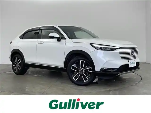 ホンダ ヴェゼル ハイブリッド e:HEV Z 兵庫県 2022(令4)年 1.9万km プラチナホワイトパール ・純正9インチナビ/・Bluetooth/USB/フルセグテレビ/・マルチビューカメラ/・ホンダセンシング/・衝突軽減ブレーキ/・オートハイビーム/・アダプティブクルーズコントロール/・先行車発進告知機能/・標識認識機能/・前後コーナーセンサー/・ブラインドスポットモニター/・パワーバックドア/・純正スピーカー　ディーラーオプション/・電子パーキング/・オートホールド/・ステアリングスイッチ/・ステアリングヒーター/・パドルシフト/・ハーフレザーシート/・前席シートヒーター/・純正ゴムマット/・純正18インチアルミホイールタイヤ/・LEDヘッドライト/・フォグランプ/・置くだけ充電/・社外前後ドライブレコーダー/・ビルトインETC2.0/・プッシュスタートボタン/・スマートキー/・スペアキー/・取扱説明書/・保証書