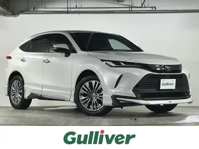 トヨタ ハリアー Z レザーパッケージ 広島県 2024(令6)年 1.1万km プラチナホワイトパールマイカ 禁煙/モデリスタエアロ/純正ナビ/フルセグTV/Bluetooth/USB/バックカメラ/JBLプレミアムサウンド/デジタルインナーミラー/ワイヤレス充電/レーダークルーズコントロール/HUD/BSM/レザーシート/メモリーシート/パワーシート/シートヒーター/シートベンチレーション/ステアリングスイッチ/ステアリングヒーター/パワーバックドア/純正アルミホイール/純正フロアマット/純正ドアバイザー/スマートキー/プッシュスタート