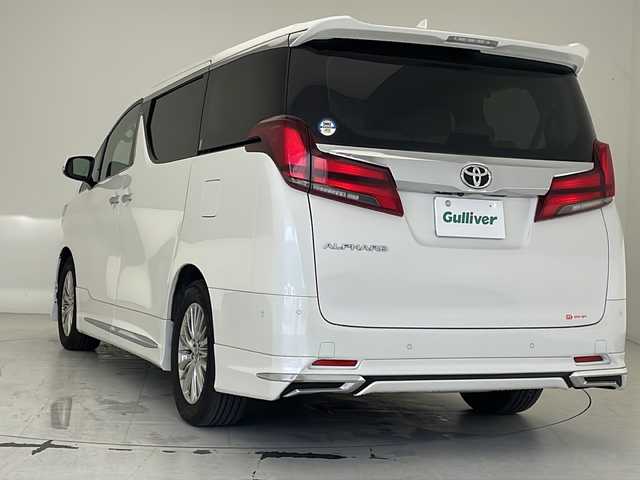 トヨタ アルファード G 沖縄県 2021(令3)年 7.1万km ホワイトパールクリスタルシャイン ワンオーナー/10．5型ナビ＋JBLプレミアムサウンド（MOP)/　（BT/DVD/CD/SD/AM/FM/USB/フルセグTV）/パノラミックビューモニター（MOP)/13.3型リアエンターテインメントシステム（MOP)/モデリスタエアロ（F・S・R）/デジタルインナーミラー（MOP)/両側パワースライドドア/パワーバックドア/ビルトインETC2.0/前後ドライブレコーダー（ZDR016）/トヨタセーフティセンス/ブラインドスポットモニター（MOP)/インテリジェントパーキングアシスト（MOP)/合皮シート/前席パワーシート/前席シートヒーター/前席シートエアコン/3眼LEDヘッドライト/オートライト/アクセサリーコンセント（AC100V)/置くだけ充電/純正17インチAW/純正フロアマット/プッシュスタート/スマートキ―/記録簿/取扱説明書/保証書