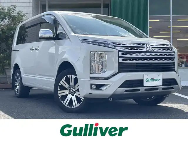 三菱 デリカＤ：５ P 岡山県 2021(令3)年 4.6万km ウォームホワイトパール 純正10.5インチナビ/フルセグTV、Bluetooth、HDMI、USB、AM、FM/純正11.5インチフリップダウンモニター/パワーバックドア/運転席パワーシート/前席シートヒーター/ステアリングヒーター/全方位カメラ/両側パワースライドドア/ETC/パドルシフト/JAOSマッドガード/パートタイム4WD/マルチLEDヘッドライト/電動パーキングブレーキ/後側方車両検知警報システム/後退時交差車両検知警報システム/三菱e-Assist/・車線逸脱警報システム/・レーダークルーズコントロール/・衝突被害軽減システム/・オートマチックハイビーム/・誤発進抑制機能