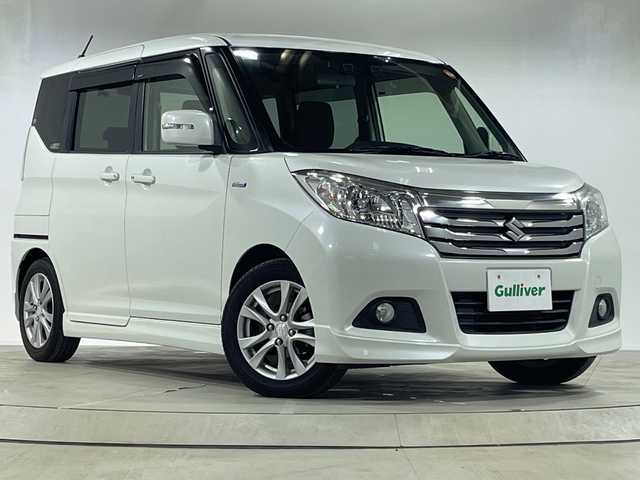 スズキ ソリオ HV MX 神奈川県 2017(平29)年 3.6万km ピュアホワイトP 社外SDナビ【CN-RE04WD】/Bluetooth・CD・DVD・SD・TV/両側パワースライドドア/クルーズコントロール/運転席シートヒーター/スペアキー1本/ETC/バックカメラ/純正フロアマット/LEDヘッドライト/オートライト/デュアルカメラブレーキサポート/誤発進抑制機能/車線逸脱警報機能/ふらつき警報機能/先行車発進お知らせ機能/エマージェンシーストップシグナル