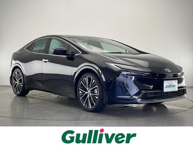 トヨタ プリウス Z 宮崎県 2024(令6)年 1.9万km アティチュードブラックマイカ 禁煙車/トヨタセーフティセンス/純正12.3型ディスプレイオーディオナビTV/（T-CONNECT/USB/HDMI/FMAM/Bluetooth/フルセグTV）/純正ビルトイン2.0ETC/純正19インチアルミ/純正LEDオートライト/純正フロアマット/プリクラッシュセーフティ/アダプティブクルーズコントロール/レーンディパーチャーアラート/オートマチックハイビーム/パーキングアシスト/クリアランスソナー/ブラインドスポットモニター/デジタルミラー/電子パーキング/オートホールド/パワーバックドア/AC100V/オートエアコン/前席シートヒーター/エアシート/運転席パワーシート/本革巻ハンドル/スマートキー/プッシュエンジンスタート/スペアキー/新車時保証書/取扱い説明書